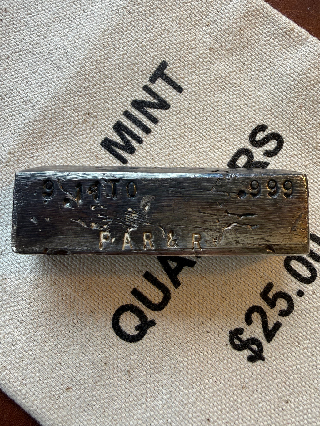 Vintage Silver Bar with 'PAR & R' branding on a textured surface.